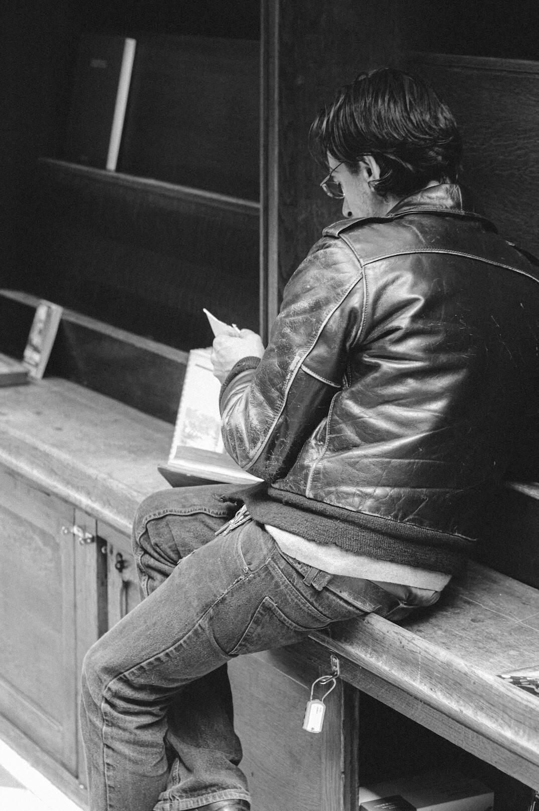 Middle-aged Swiss journalist reading through printed files in an archive