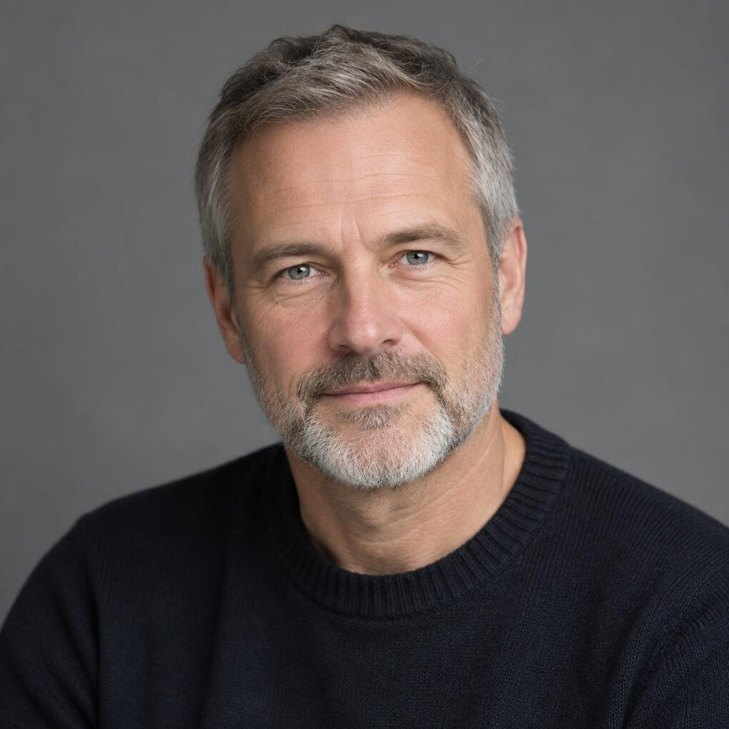 Studio portrait of a Swiss-European man in his 50s, data journalist